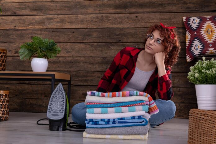 After finishing ironing the towels the girl gets dreamy and looks up TwentySomething