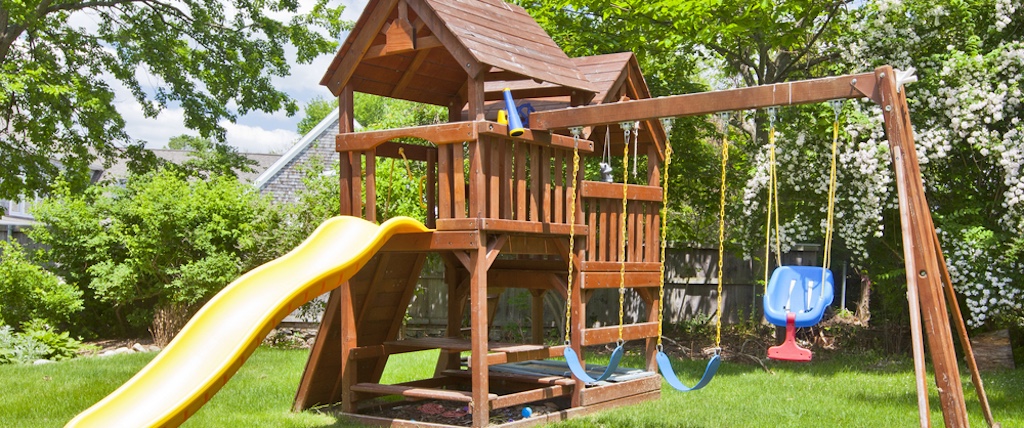Back,Yard,Wooden,Swing,Set,On,Green,Lawn